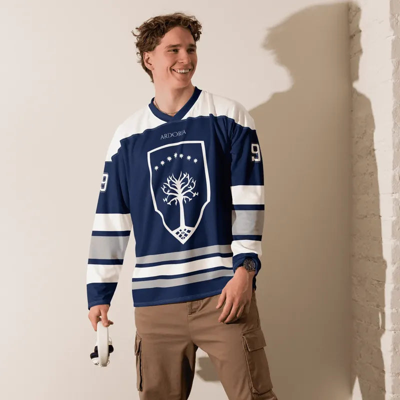 Man wearing the Gondor hockey jersey, standing against a plain wall.