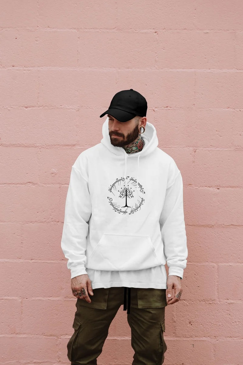 Man wearing a white hoodie with the tree of Gondor and the one ring inscription design against a pink wall