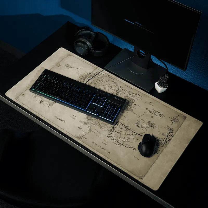 Desk setup with a keyboard, mouse, and mousepad with the design of the Middle Earth Map